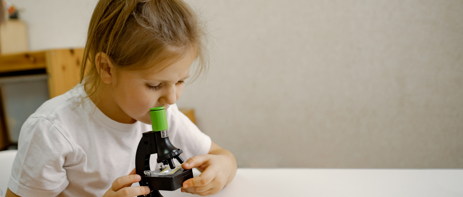 Girl looking into a microscope