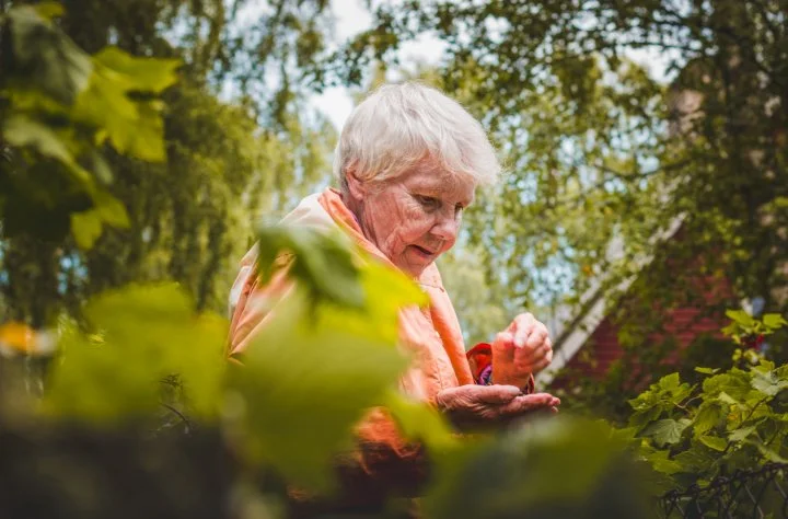 Older lady standing in a garden