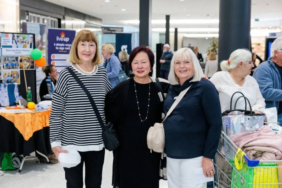 Three women at an expo