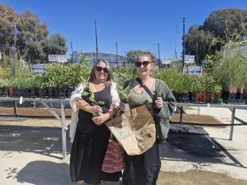 Group gathered at a community event in Joondalup where thousands of free plants are being distributed to residents to promote a greener environment.