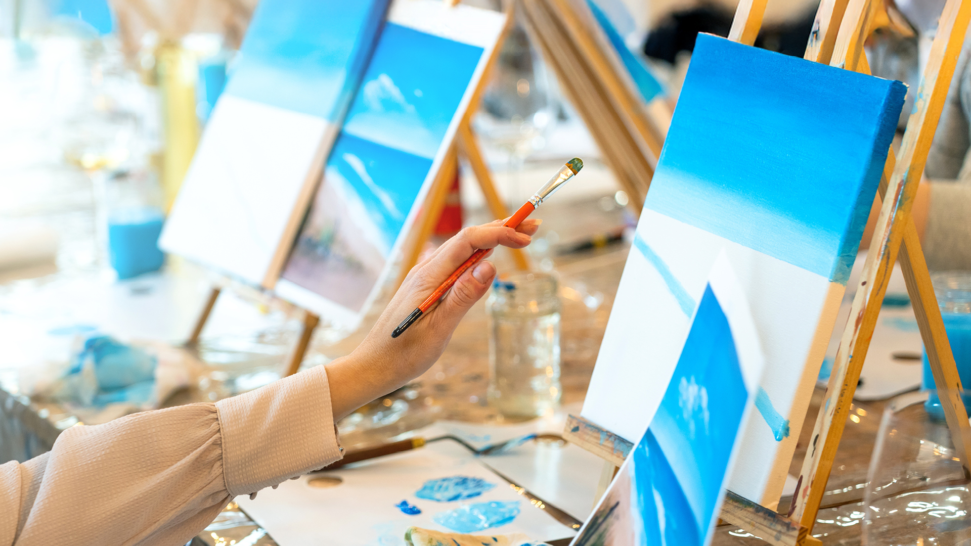 People painting on canvases