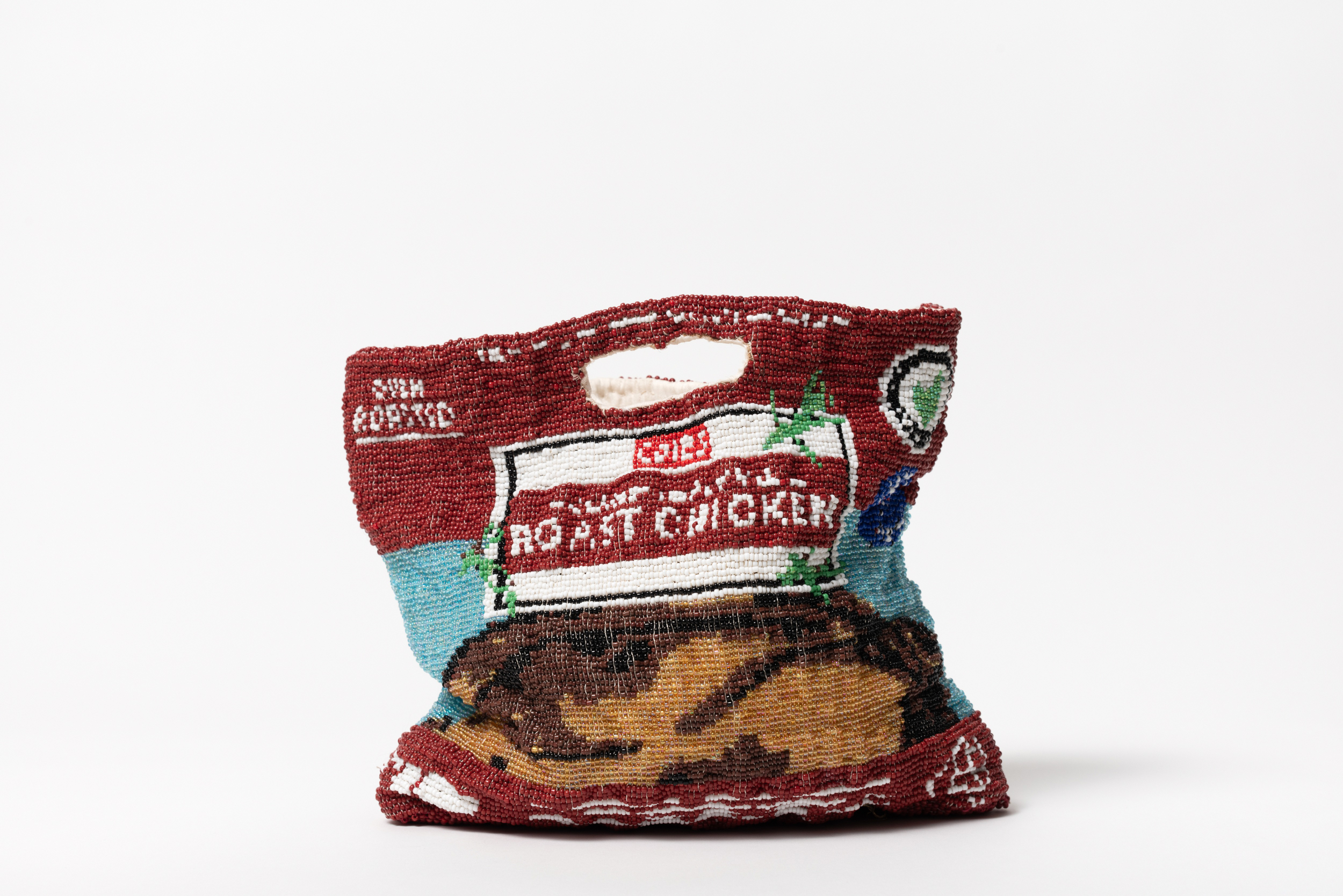 Close-up of a handcrafted beaded bag designed to resemble a roast chicken.