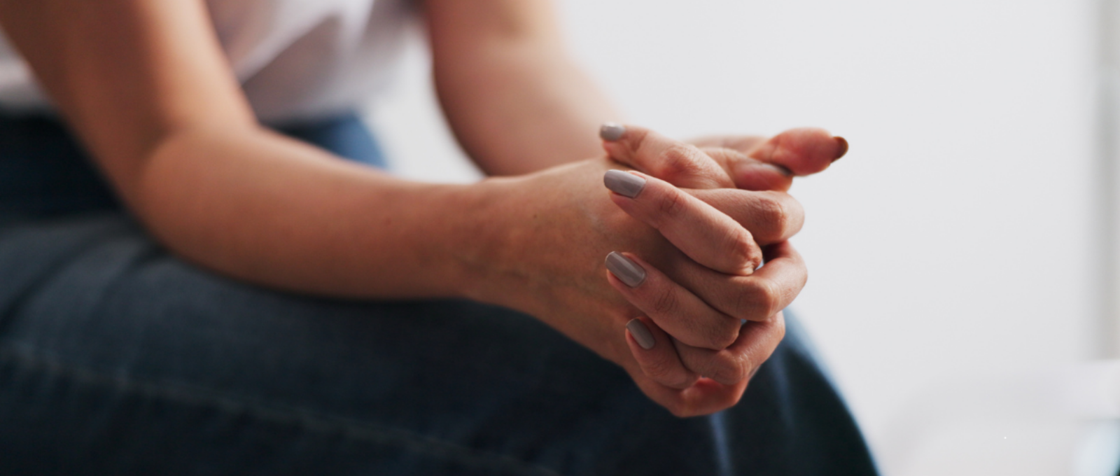 hands folded on a person's lap