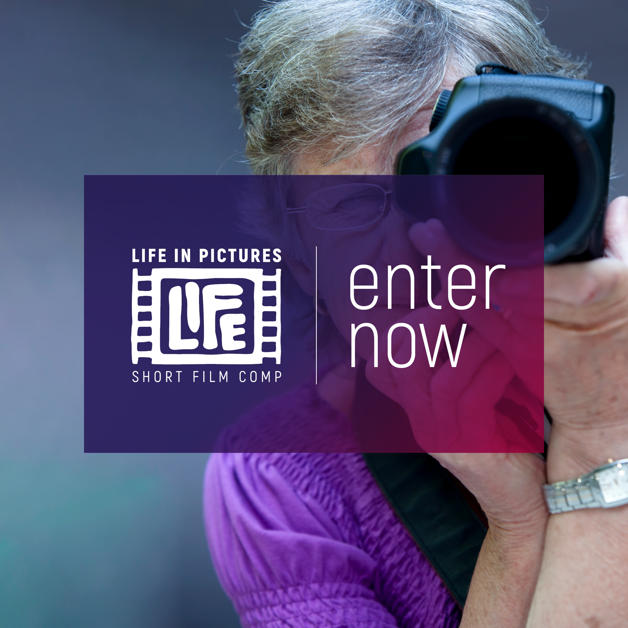 Lady looking through the lens of a camera