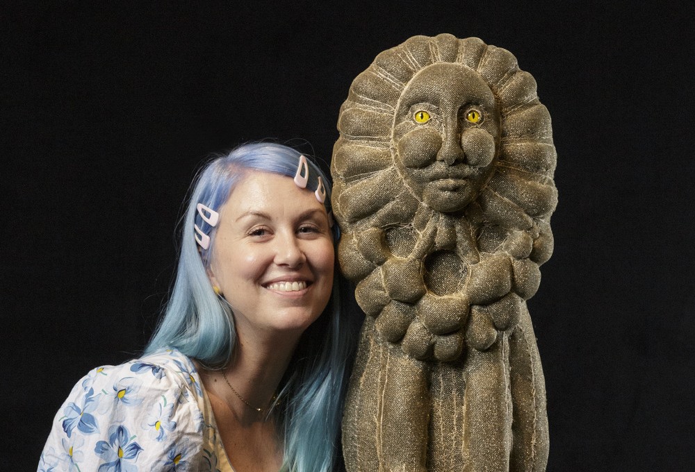 Artist Tarryn Gill standing beside sculpture 
