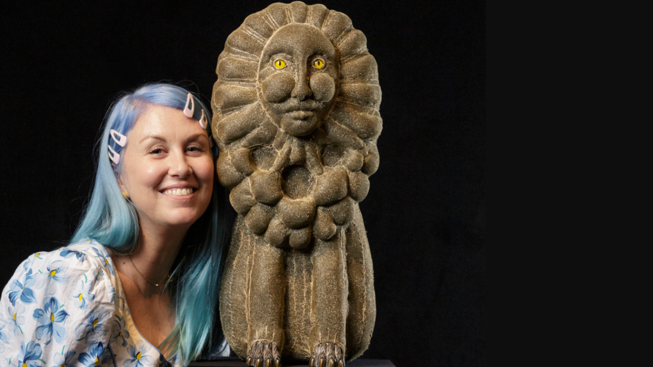 Artist Tarryn Gill standing beside sculpture 