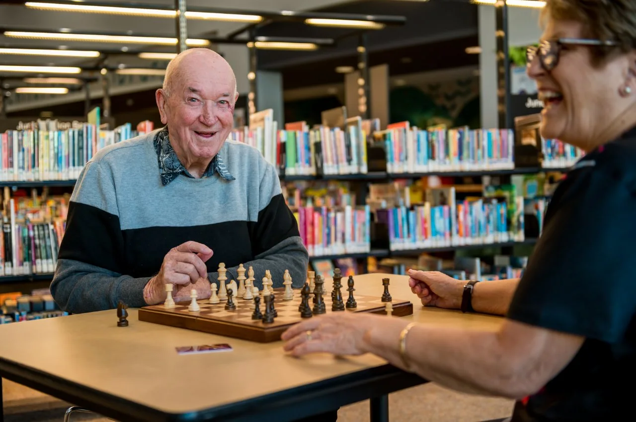 Older man sitting in the library