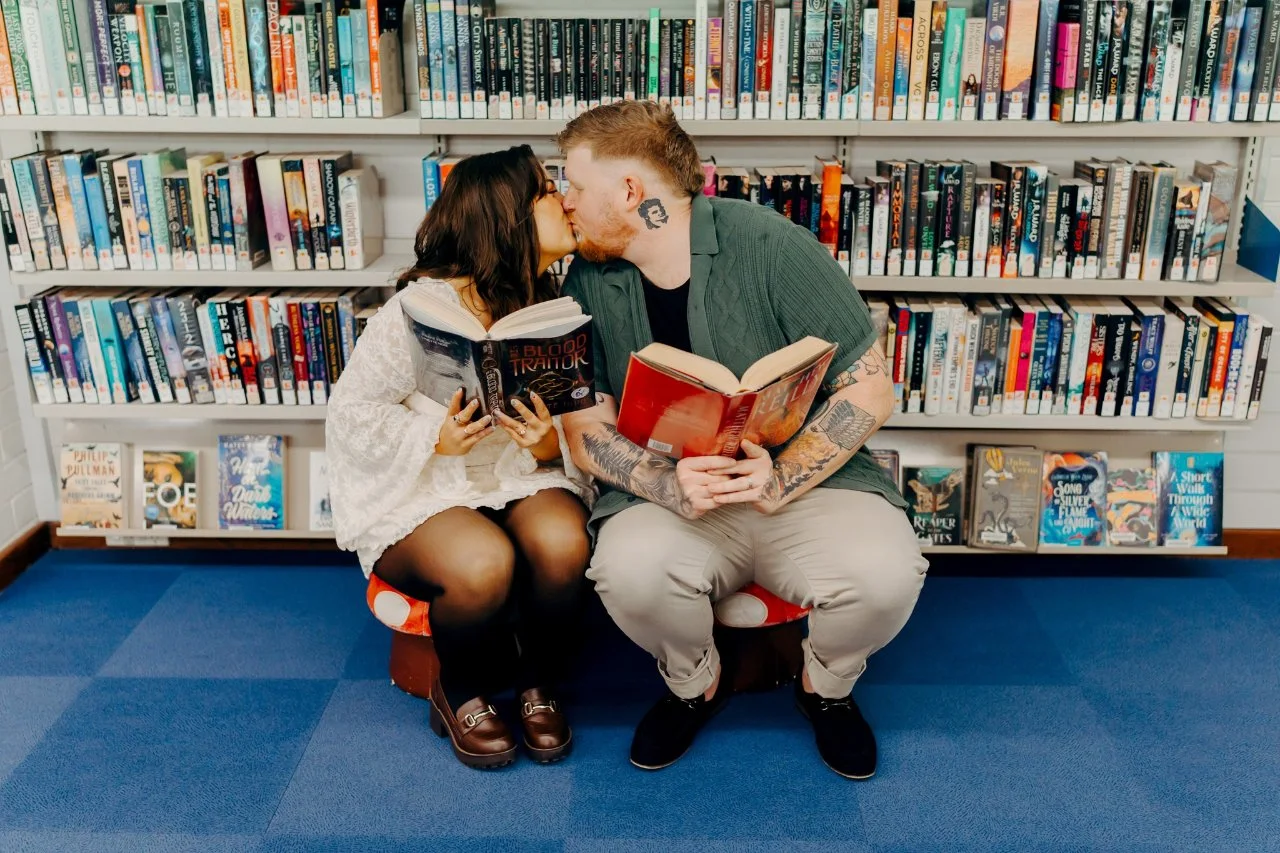 Photo of couple reading a book at Whitford Library