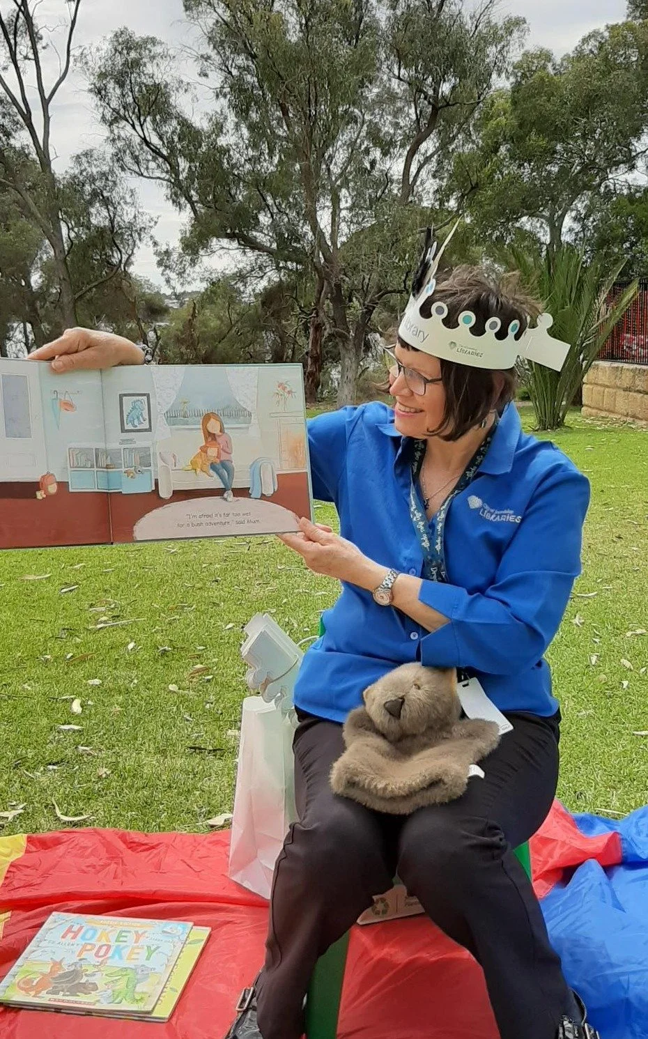 Library staff member reading a book in the par.