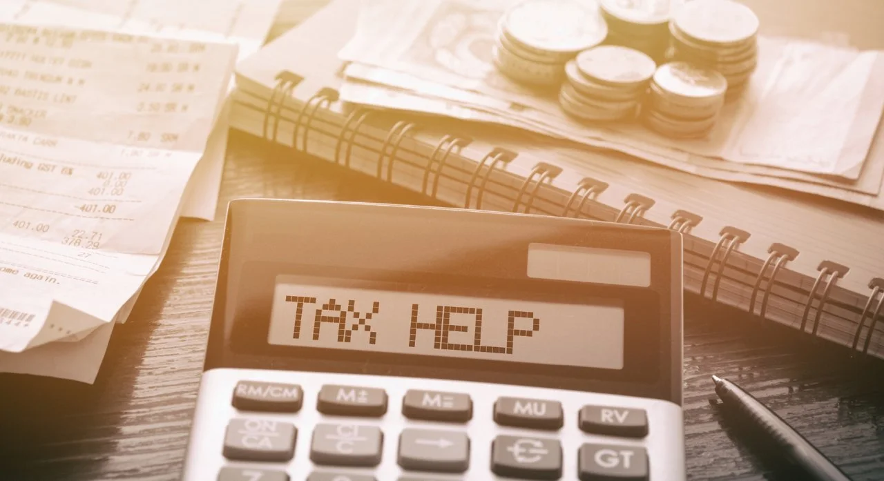 Calculator with the words Tax Help on the screen