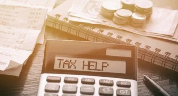 Calculator with the words Tax Help on the screen