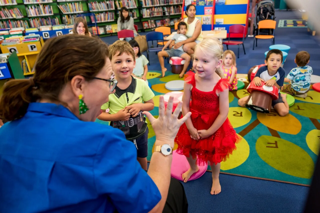Mum reading a book with her child at stotry time