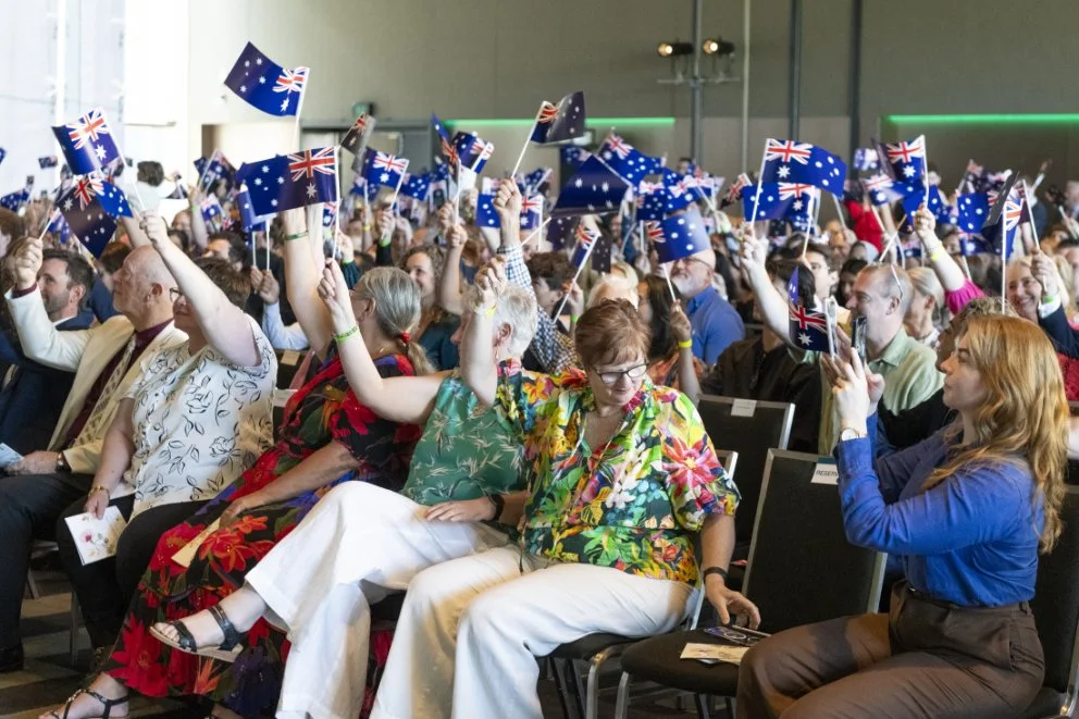 Attendees-wave-flags-during-ceremony