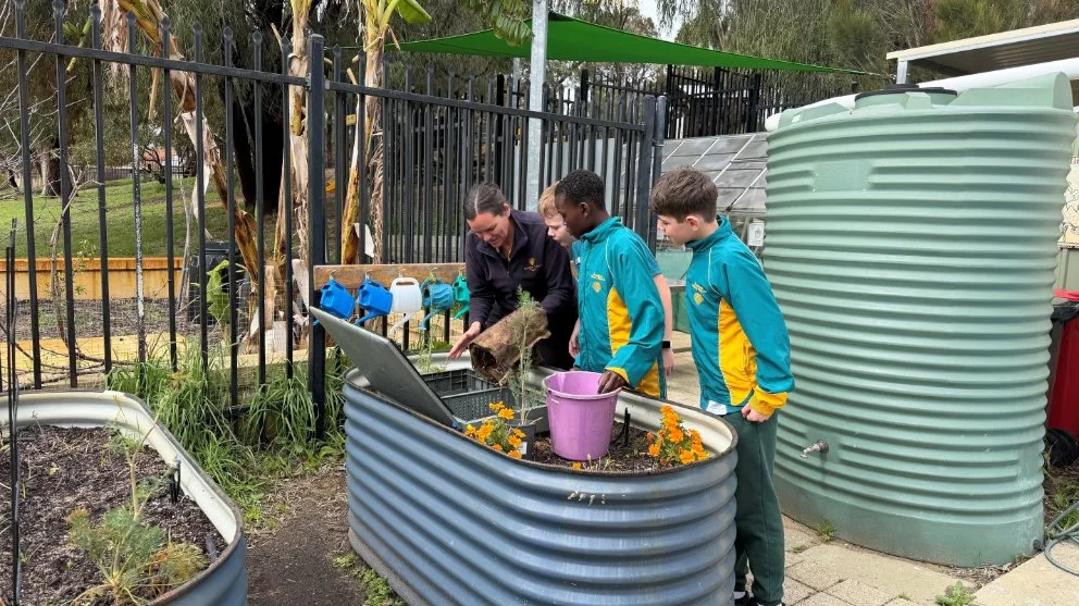 Students learning in the school garden