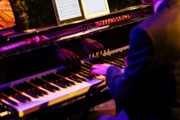 Banner with gradient background, text “Sunday Serenades,” and a stylised saxophone combined with piano keys graphic.