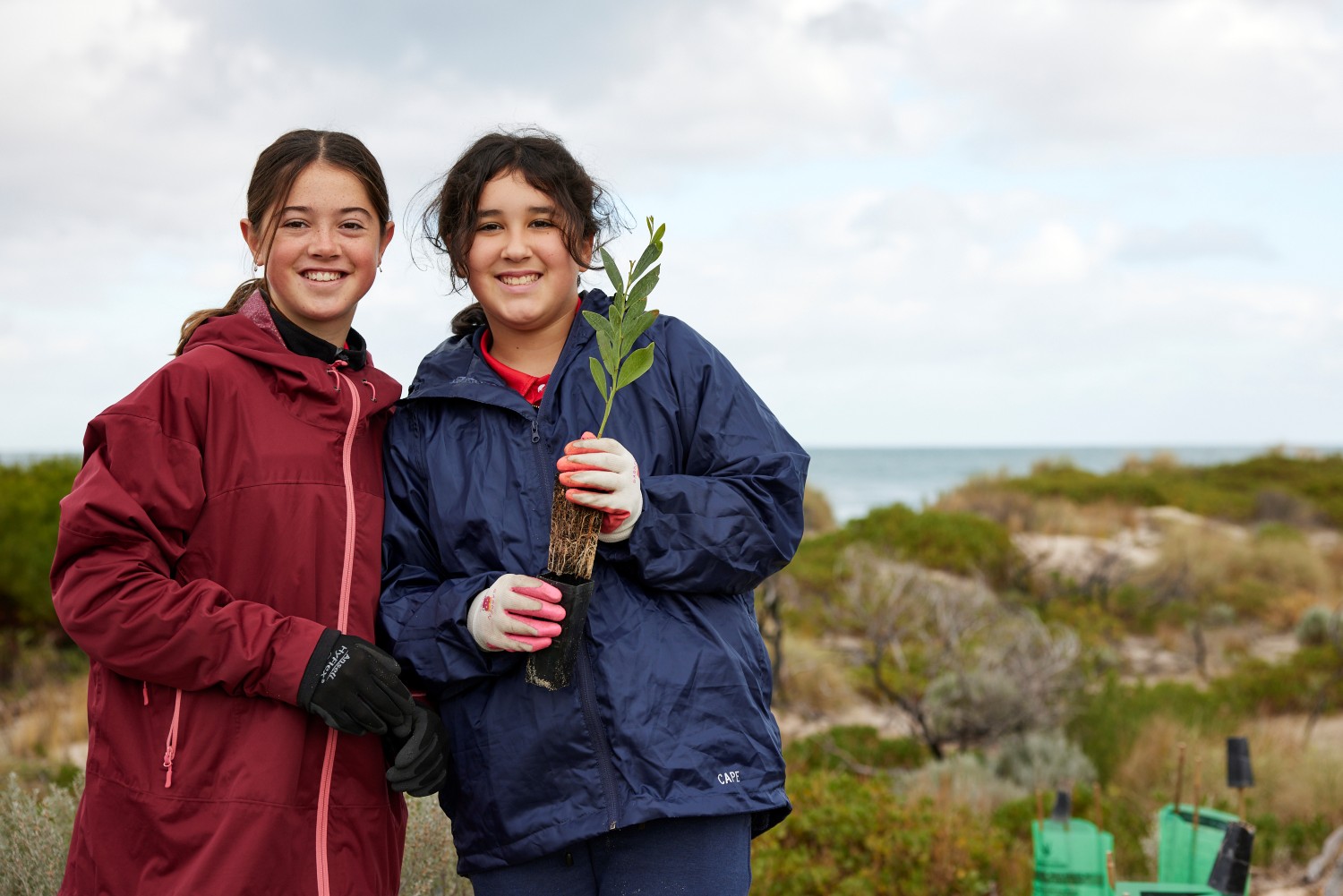 Two girls at a coastal planting event
